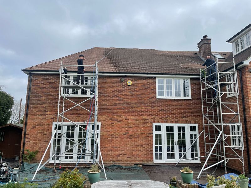 Roof cleaning carried out safely from scaffold towers by The Roof Moss Cleaners in Burgess Hill